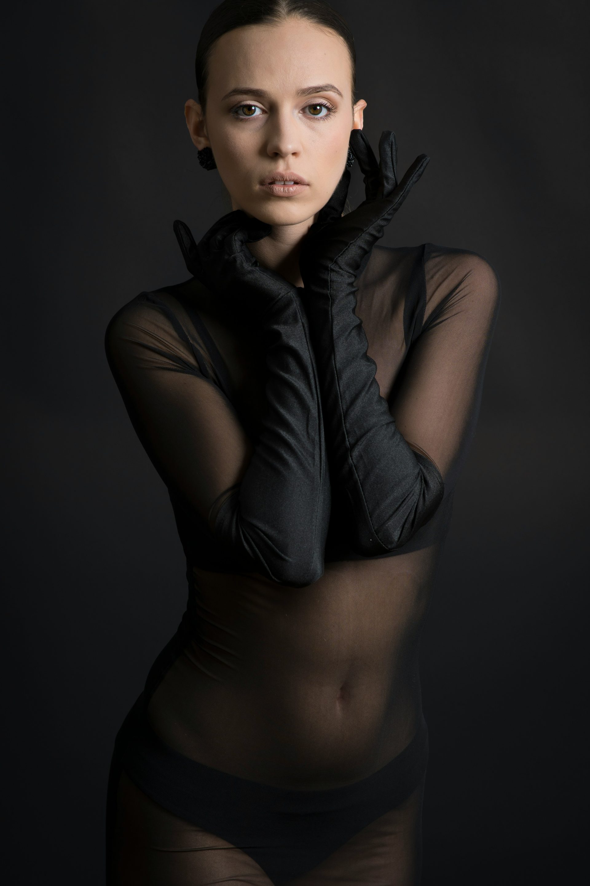 Woman in sheer top and gloves